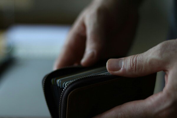 A person holding a wallet in their hand