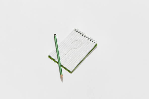 A notepad with a written question mark