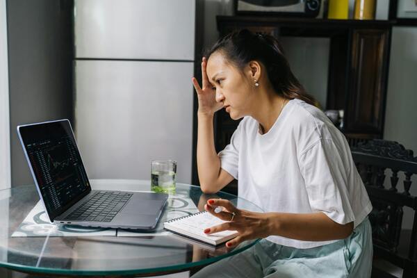 Woman looking at cryptocurrency charts on her laptop