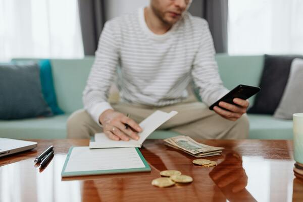 Person sitting on the couch using a mobile phone