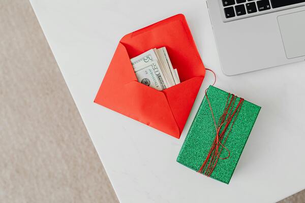 Money in a red envelope next to a green box
