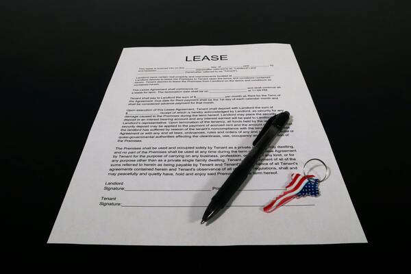Lease agreement document with pen and keychain