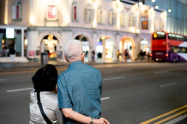 A man and a woman walking down the street