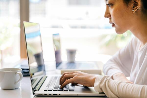Woman typing on a laptop