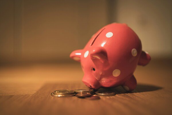 Pink piggy coin bank on a wooden table