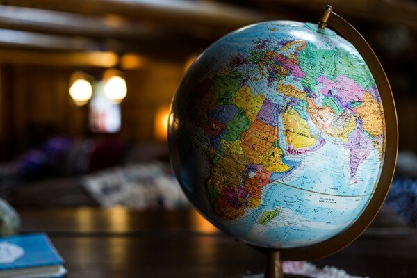 A close-up photo of a globe sitting on top of a desk