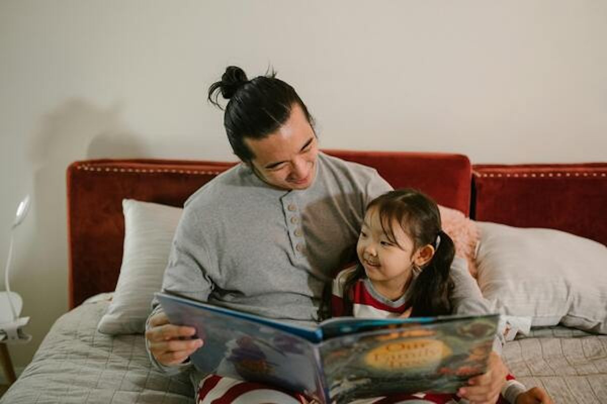 Parent reading a storybook with a child, highlighting how a financial advisor can help families plan for future financial goals.