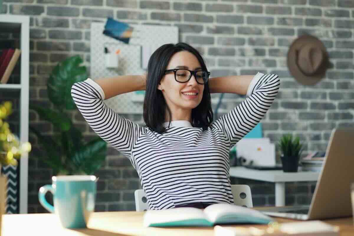 Relaxed investor at a laptop after learning how to spot greenwashing in financial products.
