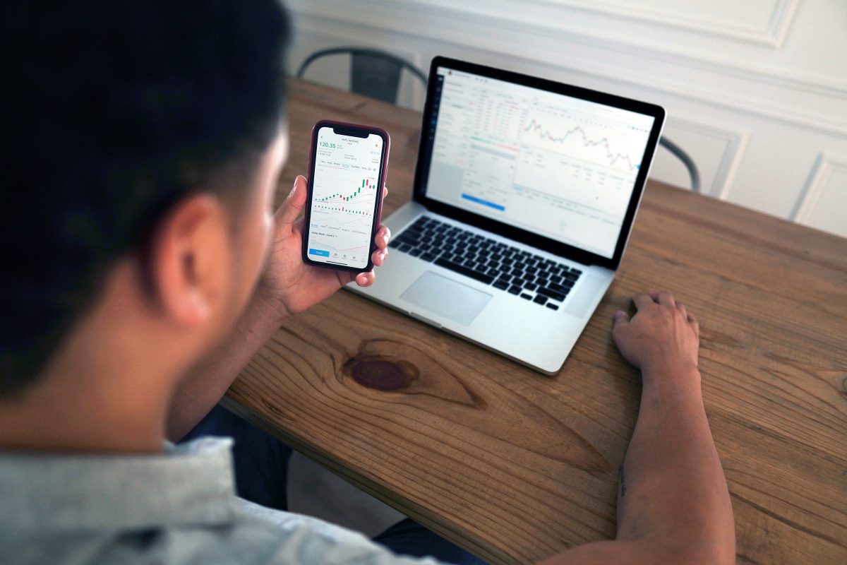 A person using his gadgets to do stock market