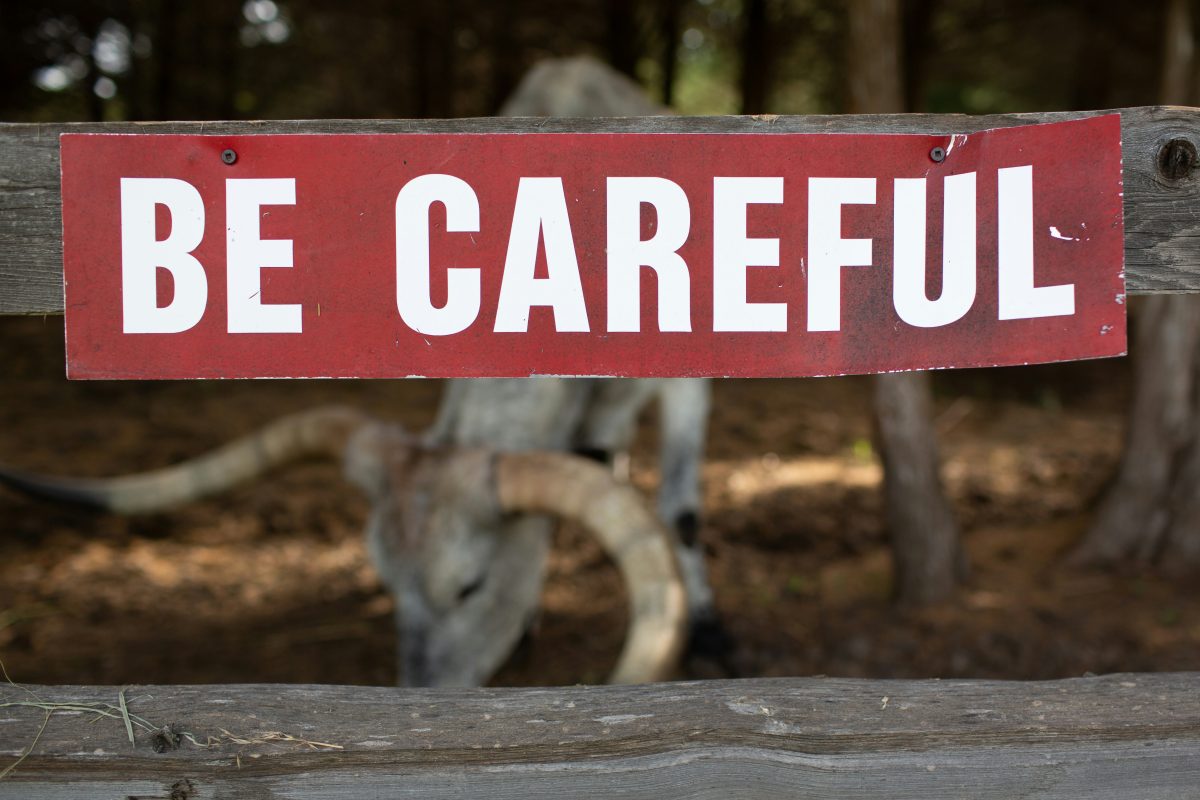 Huge be careful sign in red background