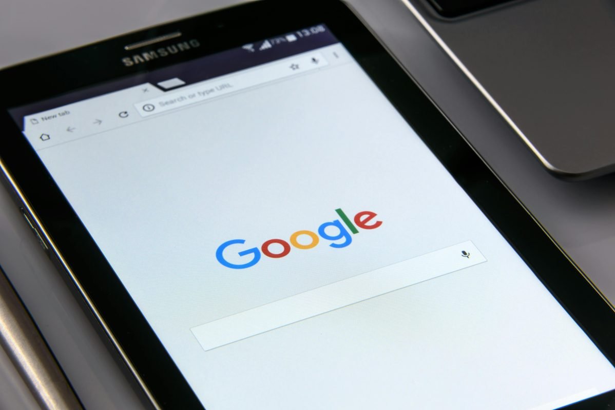 A monitor of a gadget showing google search bar