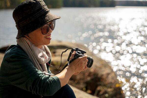 Photo of an elderly woman holding a camera