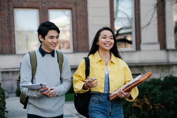 A young man and a young woman walking together