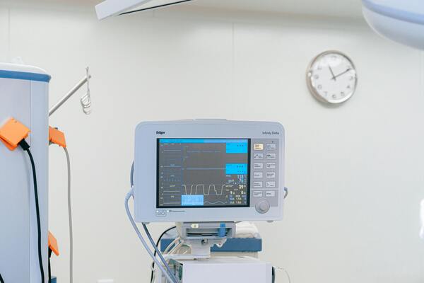 Hospital vital signs monitor displaying heart rate and patient data in a clinical care setting