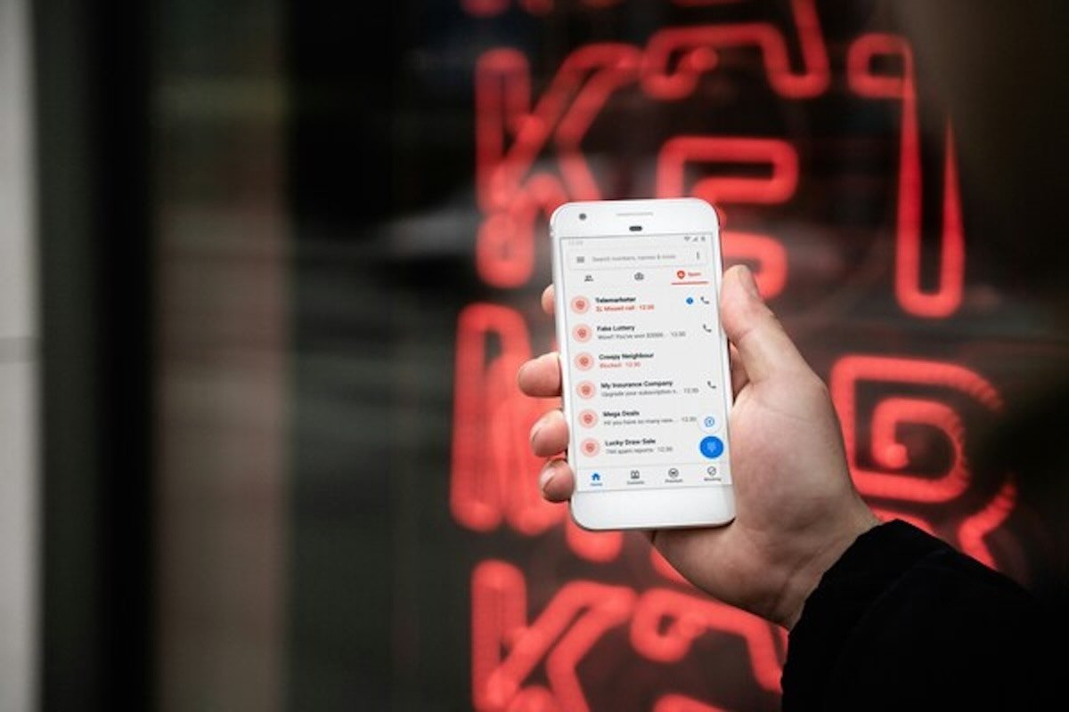 Person checking suspicious messages on a smartphone after learning how to recover money if hacked or scammed.