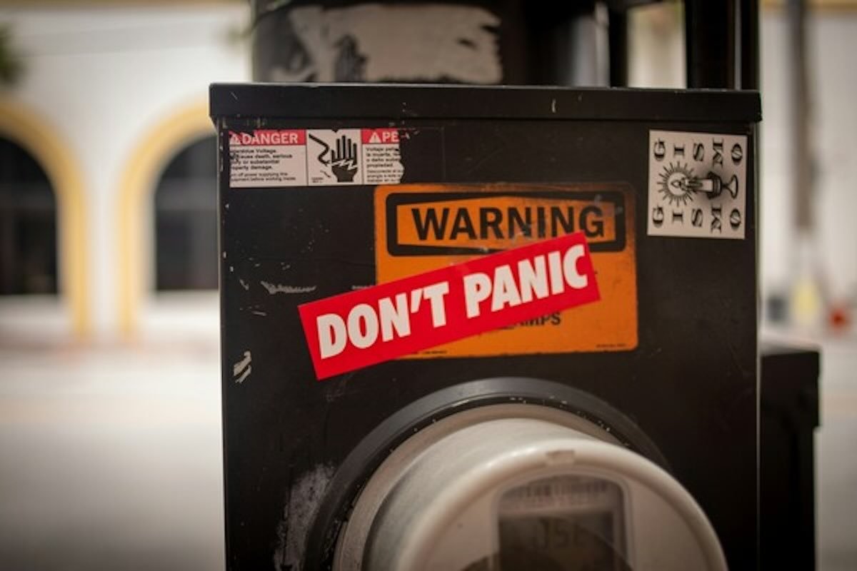 Warning sign with the words "Don't Panic", reminding victims how to recover money if hacked or scammed.