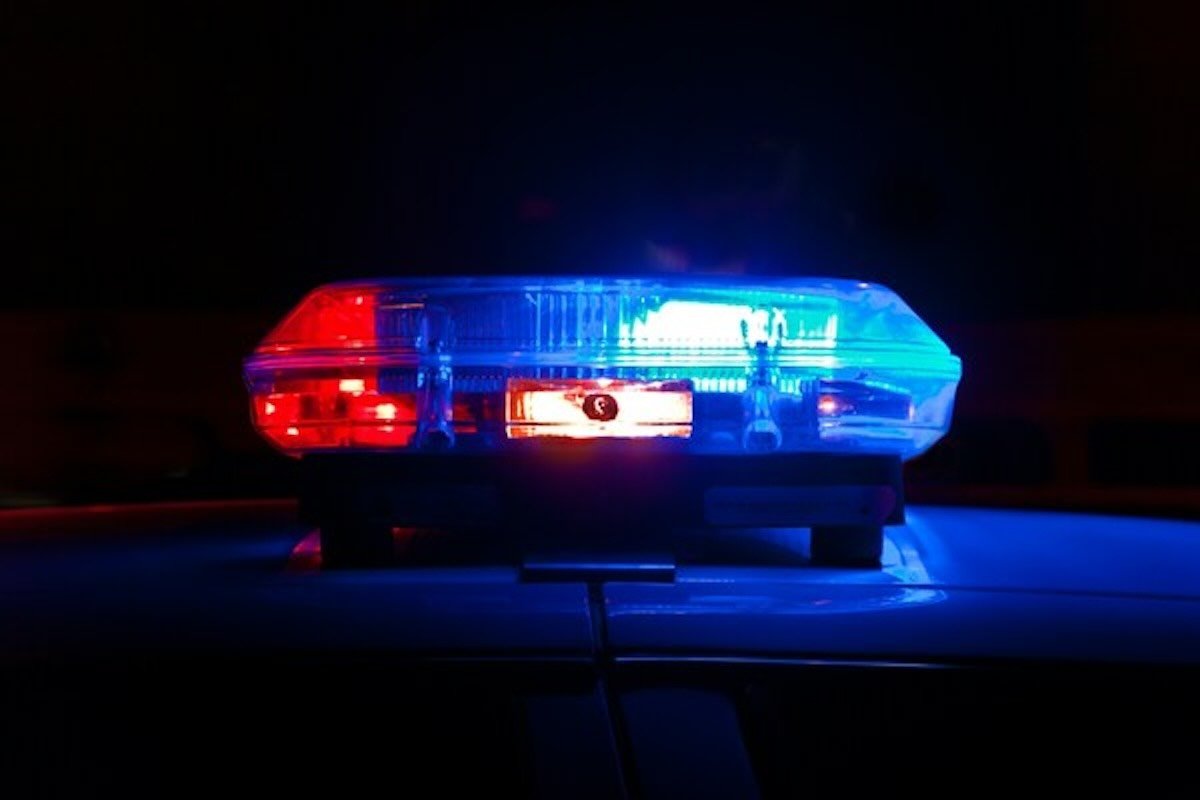 Police vehicle emergency lights, representing reporting a scam to help recover money if hacked or scammed.