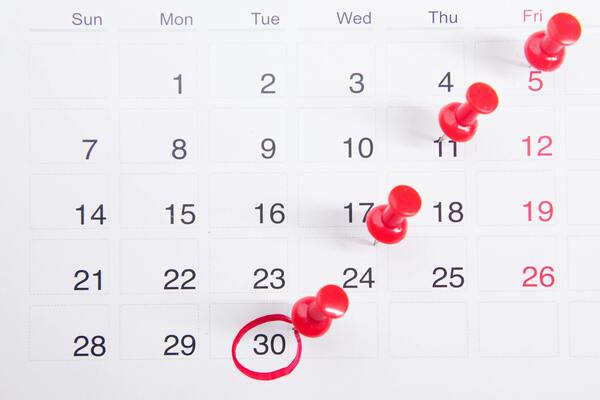 Calendar with pinned travel dates highlighted for planning vacation and travel insurance coverage.