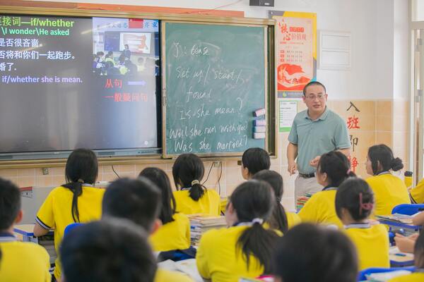 Older male teacher teaching classroom of students, second career after retirement and senior educator concept.
