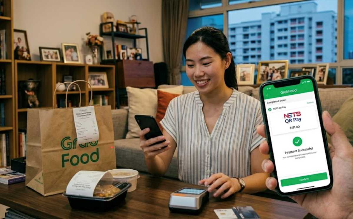 A woman using a mobile payment app to pay for a delivered meal, showing how technology has changed everyday spending decisions.